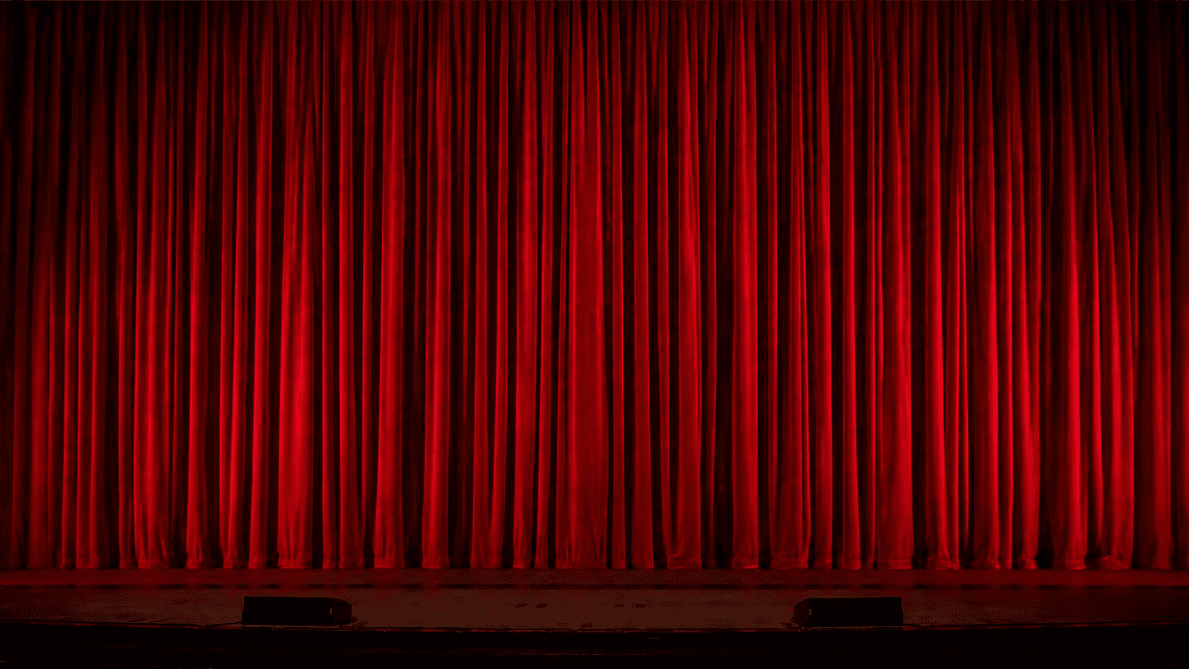 Red theatre curtain, drawn back before a screening