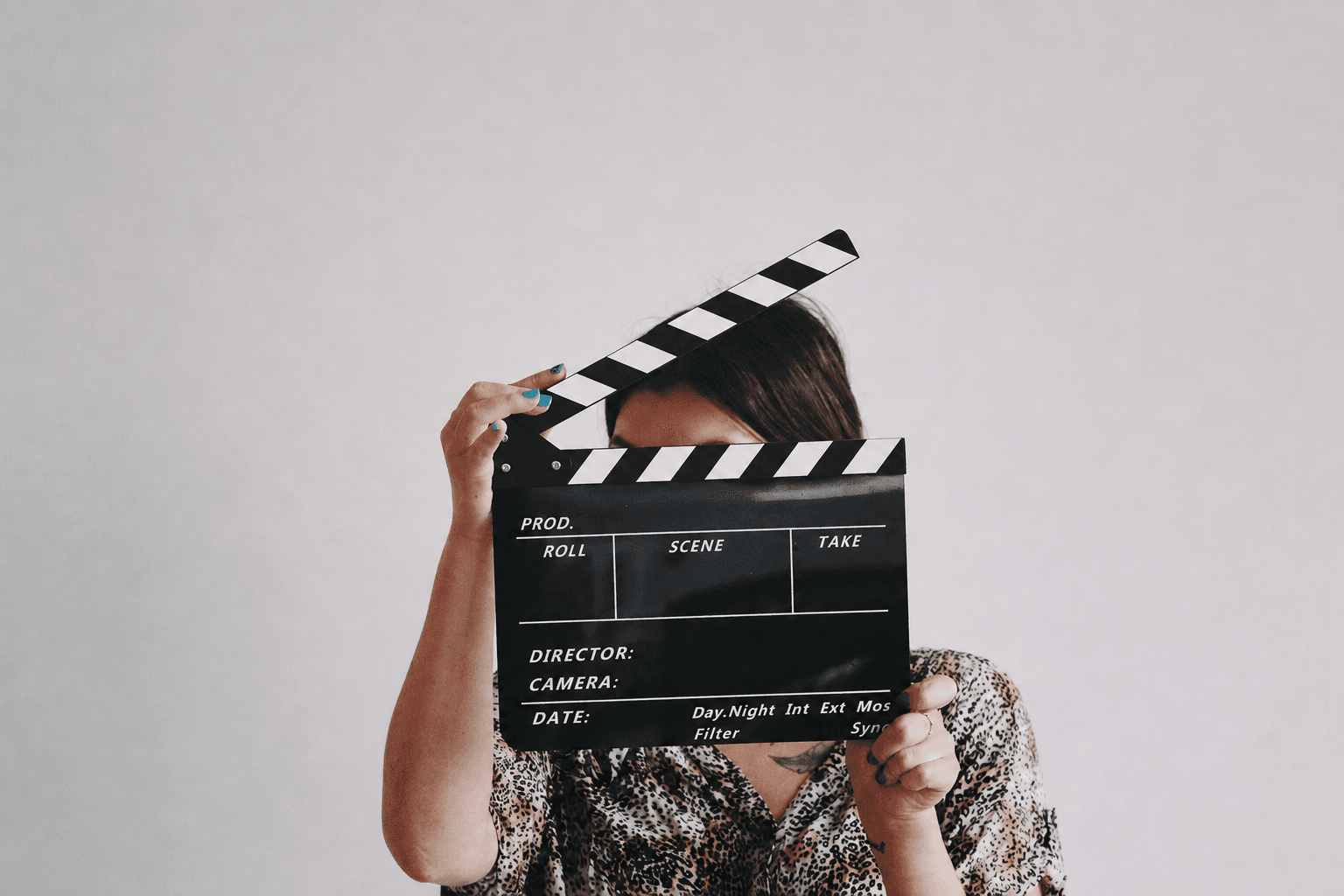 Subject framed behind a clapperboard before an interview take